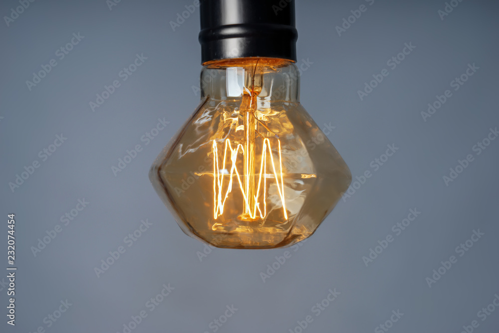 Retro light bulb on grey background