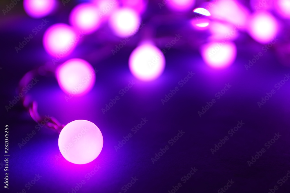 Glowing Christmas lights on dark background