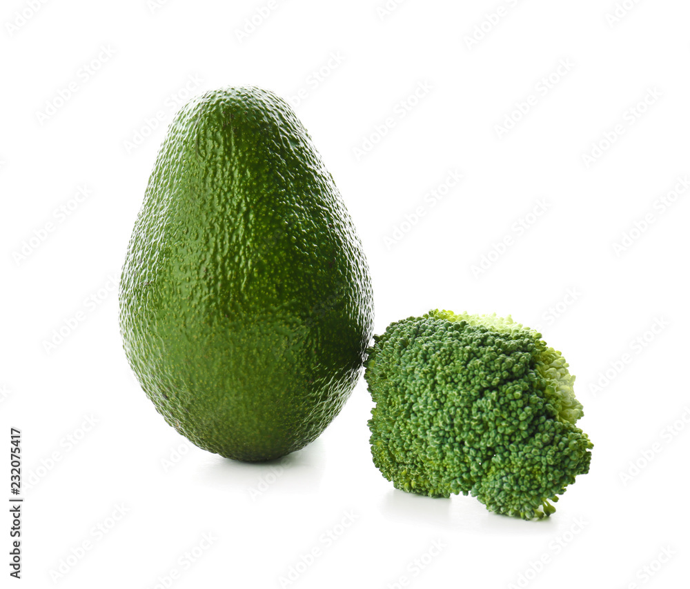 Ripe avocado and broccoli on white background