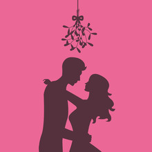 Silhouette Of Loving Couple Are Kissing Under The Mistletoe