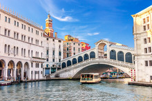 Vaporetto under the Rialto Bridge near the Fondaco dei Tedeschi, Palazzo dei Camerlenghi and the dome of San Bartolomeo in Venice