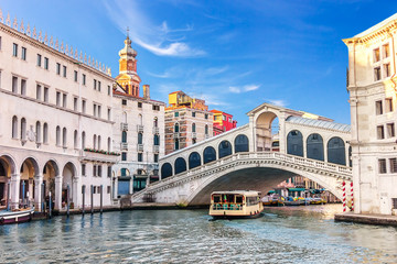 vaporetto under the rialto bridge near the fondaco dei tedeschi, palazzo dei camerlenghi and the dom