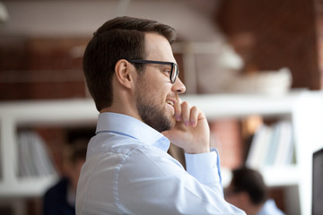 Sticker - Close up of smiling male employee in glasses talk on phone having casual conversation with friend, happy millennial man worker chat on cellphone, speak with client or consult customer online