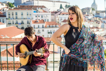 Wall Mural - Beautiful fado singer performing with handsome portuguese guitarist player, Portugal