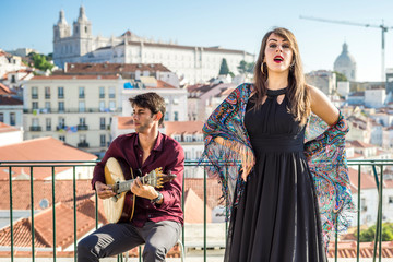 Wall Mural - Beautiful fado singer performing with handsome portuguese guitarist player, Portugal