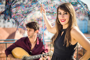 Wall Mural - Beautiful fado singer performing with handsome portuguese guitarist player, Portugal