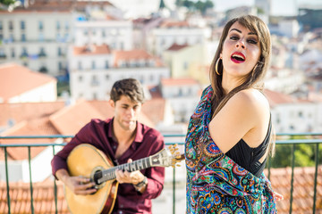 Wall Mural - Beautiful fado singer performing with handsome portuguese guitarist player, Portugal