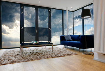 Modern living room with large windows and view on sky