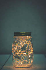 Wall Mural - Christmas fairy lights in a mason jar