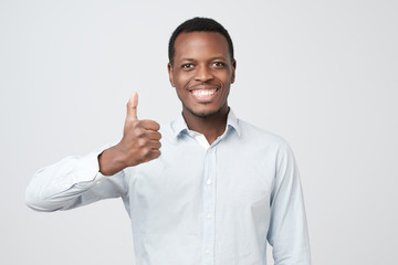 Wall Mural - Portrait of happy afroamerican handsome man laughing and showing thumb up