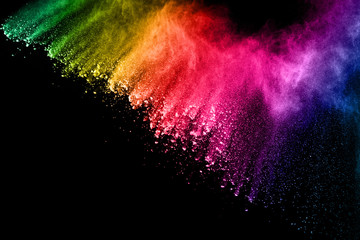 abstract colored dust explosion on a black background.abstract powder splatted background,freeze mot