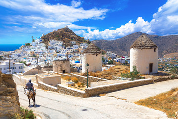 Wall Mural - Traditional houses, wind mills, churches  and donkey in Ios island, Cyclades, Greece.