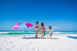 © Schultz-West Images - Three Kids on the Beach with an Umbrella