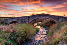 River Blyth Under Bellasis Bridge, The Humped-back Stone Bridge Is Grade 2 Listed, Seen Here At Sunset
