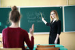 © alexkich - Young teacher in school class