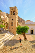Tourist Taking Photograph Of The Church Of Elkomenos Christos And Bell Tower In Platia Dsami Square, Monemvasia, Laconia, The Peloponnese, Greece, Southern Europe