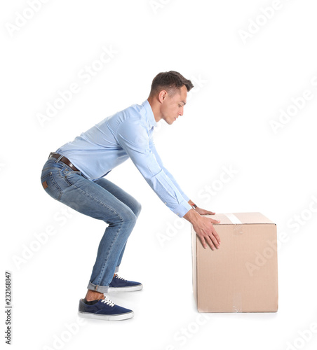 Fotografía Full length portrait of young man lifting heavy cardboard box on white background