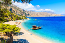 Tourist Boat Anchoring At Beautiful Apella Beach On Karpathos Island, Greece
