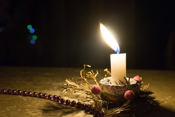 christmas table decoration with burning candle