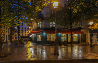 Wall Mural - Parisian street in rainy autumn evening, Paris.