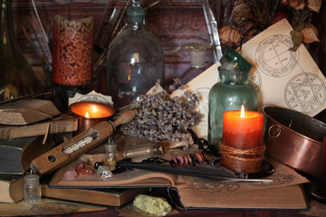 Wall Mural - Antique Magic Book. Witchcraft Peacock feathers and candle background. Black candle Magic Ritual.