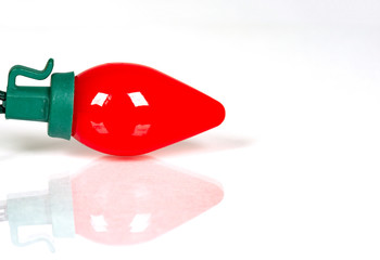 Wall Mural - red retro led bulb light with reflection isolated on white with a shallow depth of field