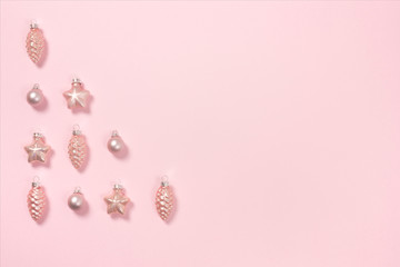 Delicate pink pastel background with beautiful pink baubles. Top view. Place for text.