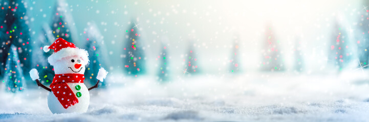 happy snowman in winter wonderland with trees and lights