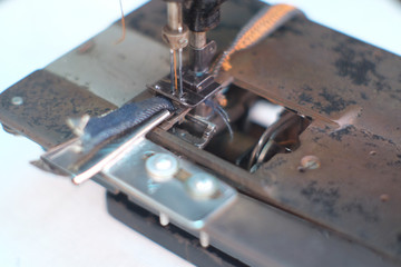 Closeup part of an old sewing machine and detail on needle & thread,presser foot