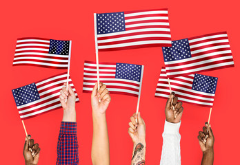 Wall Mural - Hands waving flags of the United States