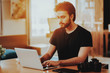 © VadimGuzhva - Portrait of Handsome Freelancer Working on Laptop