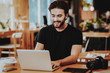 © VadimGuzhva - Portrait of Smiling Freelancer Working on Laptop