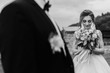 © sonyachny - Gorgeous bride with modern bouquet looking at stylish groom and smiling outdoors. Sensual wedding couple posing. Romantic moments of newlyweds. Wedding photo