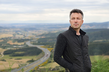 handsome man. outdoor male portrait over nature landscape in navarre, spain.