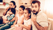 © Vadym Huzhva - Cheerful Family Watching Scary Movie at Home