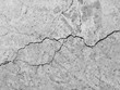 © srckomkrit - Cracked concrete texture closeup background