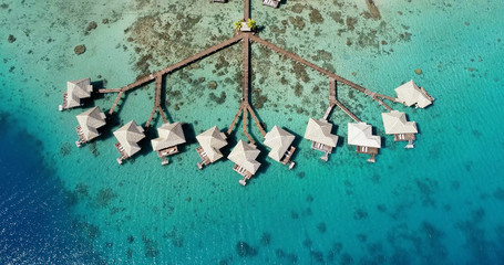 bungalow on the water in aerial view, french polynesia