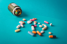 Multicolored Isolated Pills And Capsules  On Blue Background