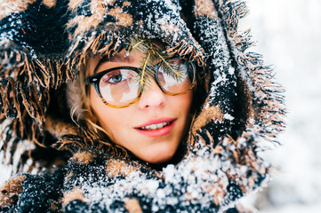 Unusual cute girl creative lifestyle fashion pottrait. Odd strange lovely funny woman in glasses. Graceful beatiful female smiling sensual face. Bizzare rebel lady wearing winter clothes. Snowy scarf.