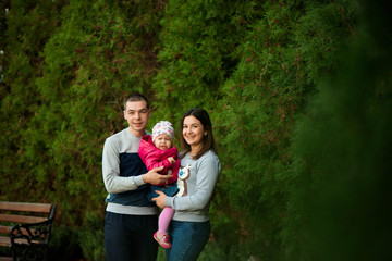 Wall Mural - Family portrait, parents with daughter, autumn family portrait.