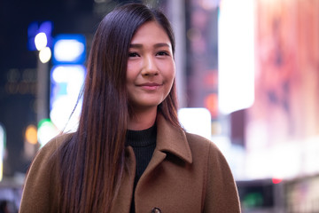 Canvas Print - Young Asian woman in city at night