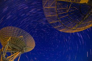 radio telescope on the background of stellar tracks