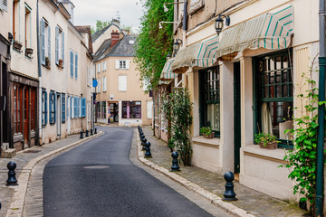 Fototapete - Old street with old houses in a small town Chartres, France
