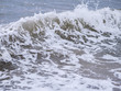 Waves at the seashore. Selective focus with shallow depth of field.