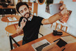 © VadimGuzhva - Guy in Headphones Makes Selfie Works at Workplace