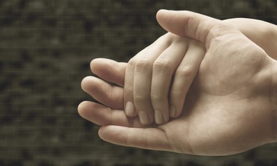 Wall Mural - Hands of man and woman holding together