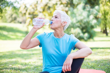 Wall Mural - Happy senior lady relaxing after training