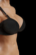 © PixlMakr - Woman in black bra isolated on black background