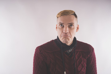 charismatic man dressed in a red sweater and posing on a white background