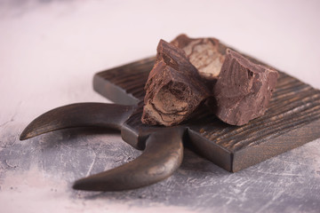 Wall Mural - Slices of milk chocolate on a wooden surface